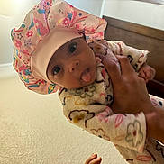 Damarionna joined the competition — help win amazing prizes! baby, child, clothing, cozy, cute, expression, face, floral, hand, indoor, infant, pattern, person, playful, portrait, shower_cap, stars, tongue, unicorn, wooden_door