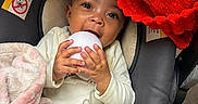 Damarionna joined the competition — help win amazing prizes! baby, baby_toys, blanket, bottle, car_seat, child, clothing, cozy, cute, face, feeding, hand, happy, indoors, infant, milk_bottle, portrait, red_blanket, smiling, white_object