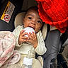 Damarionna joined the competition — help win amazing prizes! baby, infant, car_seat, blanket, red_blanket, bottle, milk_bottle, white_object, cute, child, indoors, clothing, feeding, happy, smiling, face, hand, cozy, portrait, baby_toys