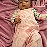 Damarionna is registered to the contest to win money with this photo: baby, child, infant, pink_blanket, pink_overall, heart_patch, cherry_prints, lying_down, soft_texture, cute, calm_expression, indoors, clothing, face, person, portrait, young_child, sleepwear, cozy, relaxed