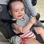 baby, smiling, stroller, toy, striped_clothing, child, infant, seatbelt, happy, cute, hand, face, cheerful, comfort, indoor, person, plush, head, eyes, skin