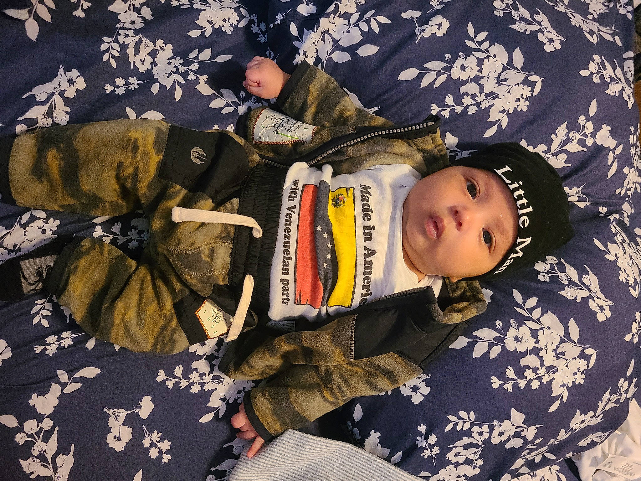 Evan joined the competition — help win amazing prizes! baby, baby_products, baby_toddler_clothing, child, comfort, fashion_accessory, hat, headgear, headwear, linens, military_camouflage, pattern, person, room, sitting, sleeve, suit, textile, toddler, tree