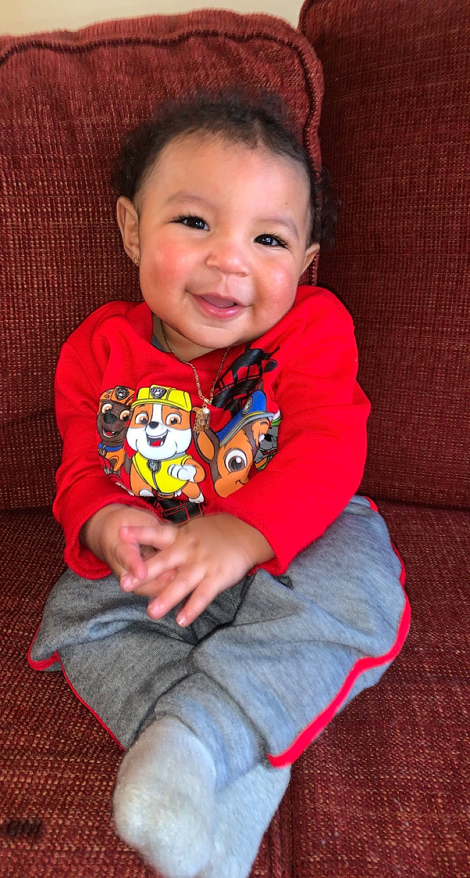 Kaleb is registered to the contest to win money with this photo: arm, baby_toddler_clothing, cheek, chin, clothing, face, facial_expression, finger, happy, head, iris, joy, leg, mouth, nose, orange, person, skin, sleeve, smile