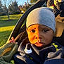 Jahvi is registered to the contest to win money with this photo: baby, beanie, bodypart, bonnet, cap, clothing, coat, face, glove, grass, hat, head, hood, jacket, knitwear, person, photography, plant, portrait, sweater