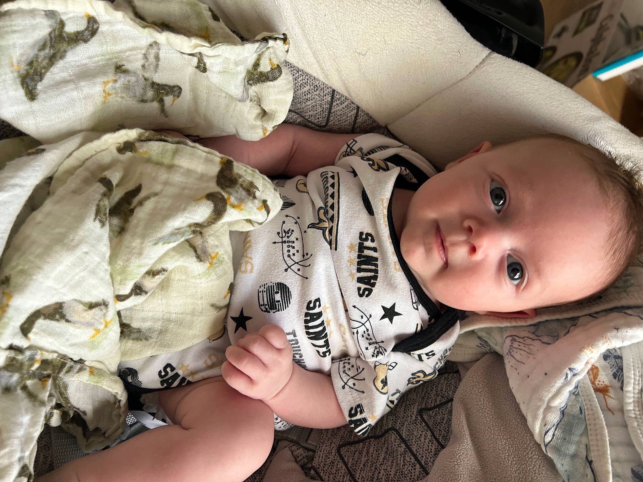 Cooper is registered to the contest to win money with this photo: baby, baby_products, baby_toddler_clothing, cheek, child, comfort, comfort_food, eyelash, happy, mammal, nail, pattern, person, personal_protective_equipment, sitting, skin, sleeve, smile, toddler, vertebrate