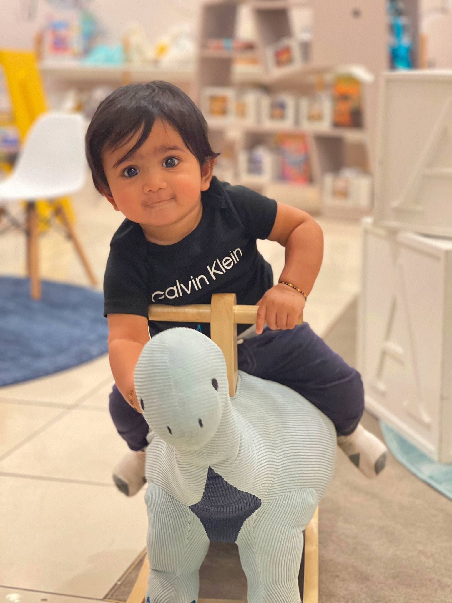 Divith joined the competition — help win amazing prizes! arm, baby, child, floor, flooring, fun, happy, human_body, joint, leg, person, room, shelf, sitting, skin, sleeve, standing, t_shirt, thigh, toddler