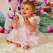 Oakley is registered to the contest to win money with this photo: baby, child, easter_eggs, golden_eggs, pink_dress, smiling, sitting, fluffy_rug, cartoon_bunny, colorful_background, festive, holiday, indoors, portrait, cute, happy, celebration, toy, easter_theme, person