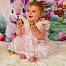 baby, child, easter_eggs, golden_eggs, pink_dress, smiling, sitting, fluffy_rug, cartoon_bunny, colorful_background, festive, holiday, indoors, portrait, cute, happy, celebration, toy, easter_theme, person