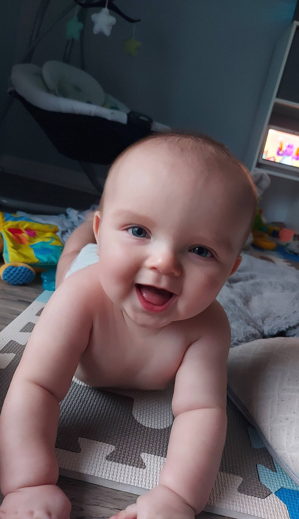 Hunter is registered to the contest to win money with this photo: baby, cheek, chest, child, eyebrow, flooring, fun, happy, iris, joy, lip, mouth, nose, person, room, sitting, skin, smile, television, toddler