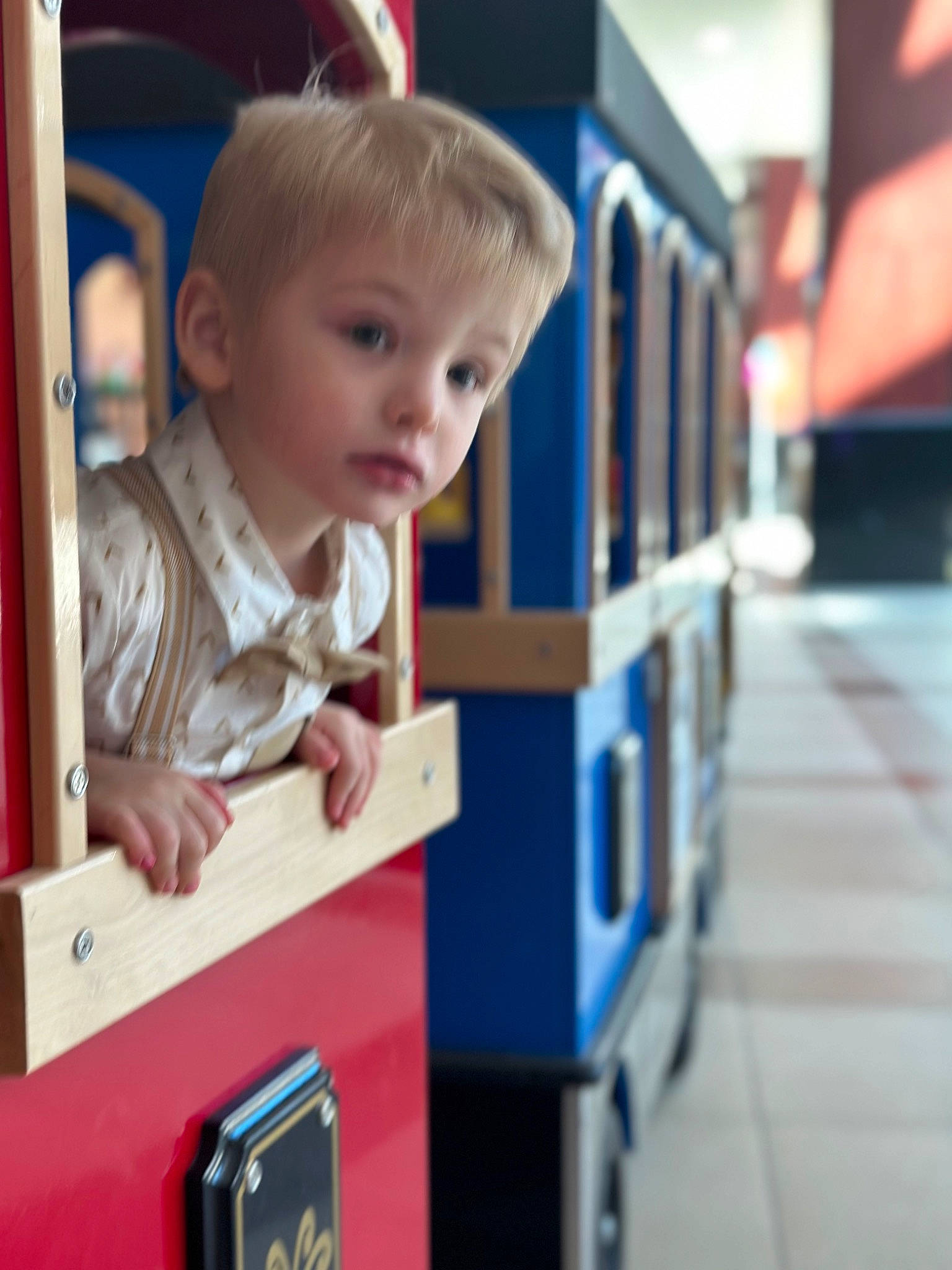 Charlie is registered to the contest to win money with this photo: baby, baby_products, baby_toys, child, city, electric_blue, face, flooring, fun, happy, leisure, nose, outdoor_play_equipment, person, play, recreation, room, shelf, sitting, toddler