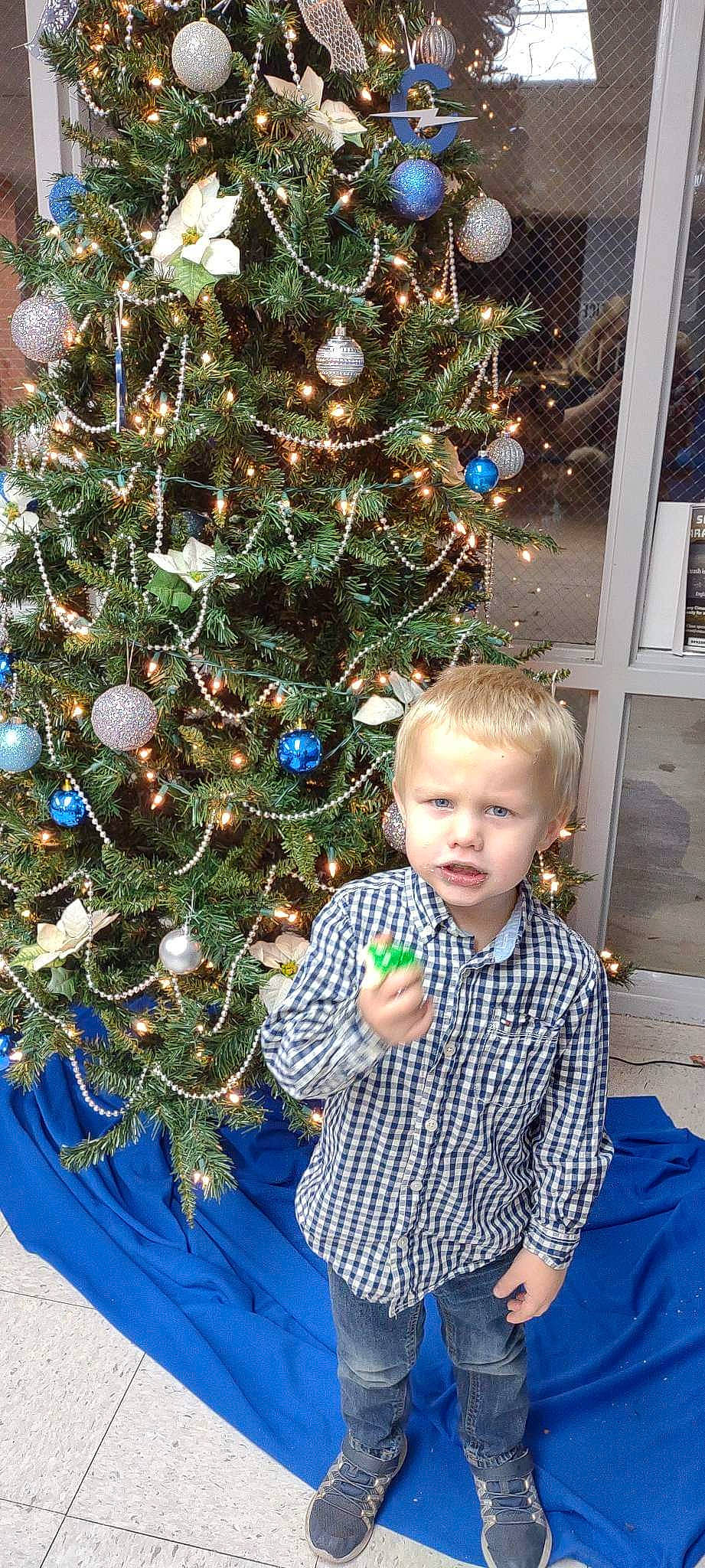 Jax joined the competition — help win amazing prizes! blue, christmas_decoration, christmas_ornament, christmas_tree, event, evergreen, green, holiday, holiday_ornament, human_body, leaf, ornament, people, person, photograph, plant, snapshot, standing, tartan, toddler
