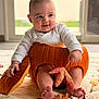 Solann a rejoint le concours — aidez-le/la à gagner de superbes lots ! baby, pumpkin, autumn_leaf, fall, cute, infant, indoor, blanket, smile, child, seasonal, orange, leaf, legs, feet, holding, hollowed_pumpkin, cozy, playful, portrait