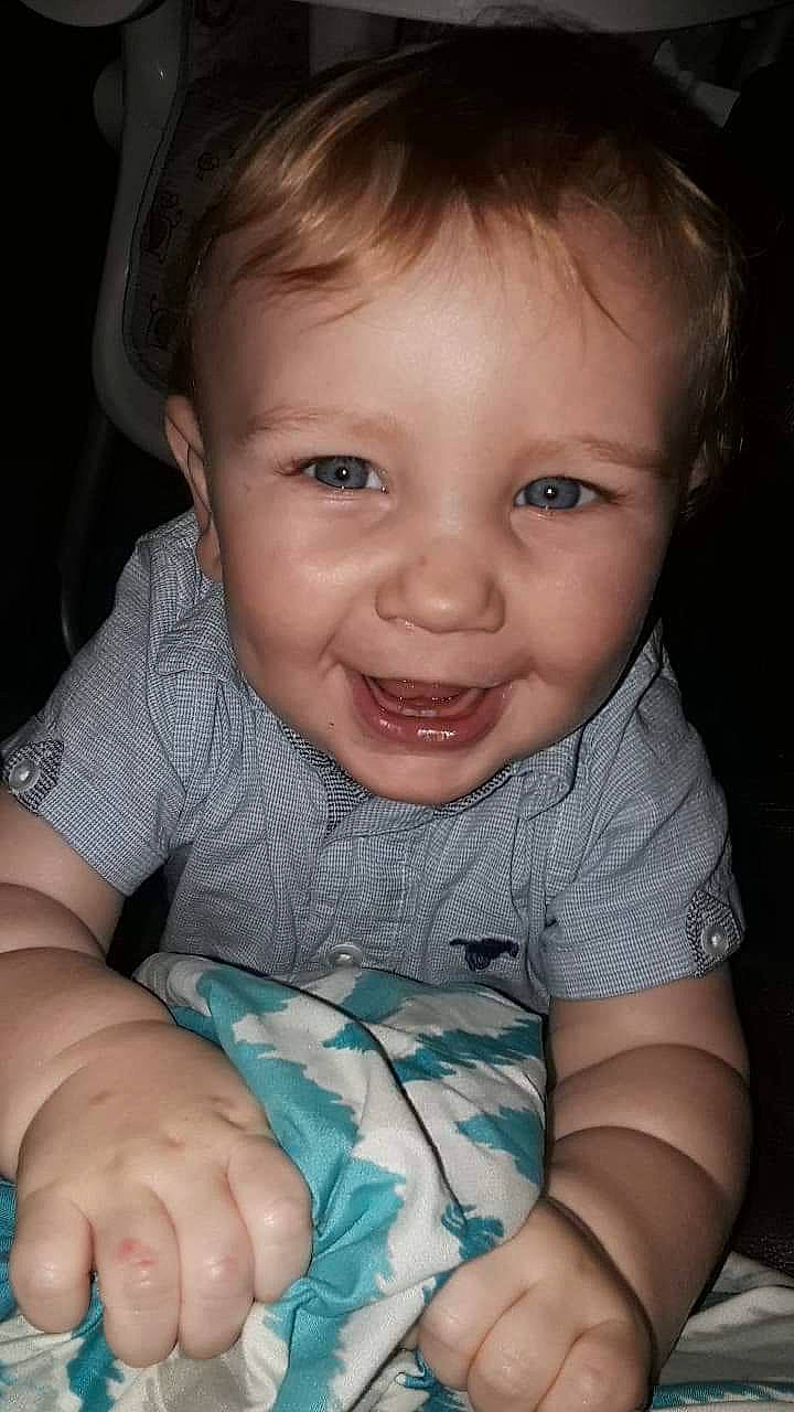 Dino is registered to the contest to win money with this photo: beauty, boy, cheek, child, chin, emotion, eye, face, facial_expression, finger, hand, head, human_hair_color, infant, joy, mouth, nose, person, sitting, skin