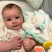 Ahsoka Murray is registered to the contest to win money with this photo: baby, infant, plush_toy, blanket, sleepy_toy, cozy, cute, soft_toy, patterned_clothing, hand, face, blue_eyes, indoor, closeup, smiling, newborn, child, comfort, warm, resting