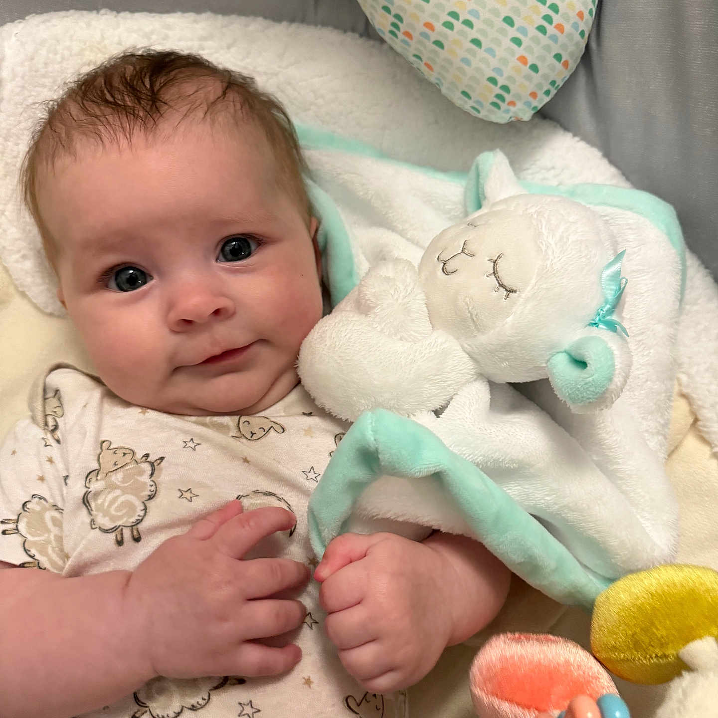 Ahsoka Murray is registered to the contest to win money with this photo: baby, blanket, blue_eyes, child, closeup, comfort, cozy, cute, face, hand, indoor, infant, newborn, patterned_clothing, plush_toy, resting, sleepy_toy, smiling, soft_toy, warm