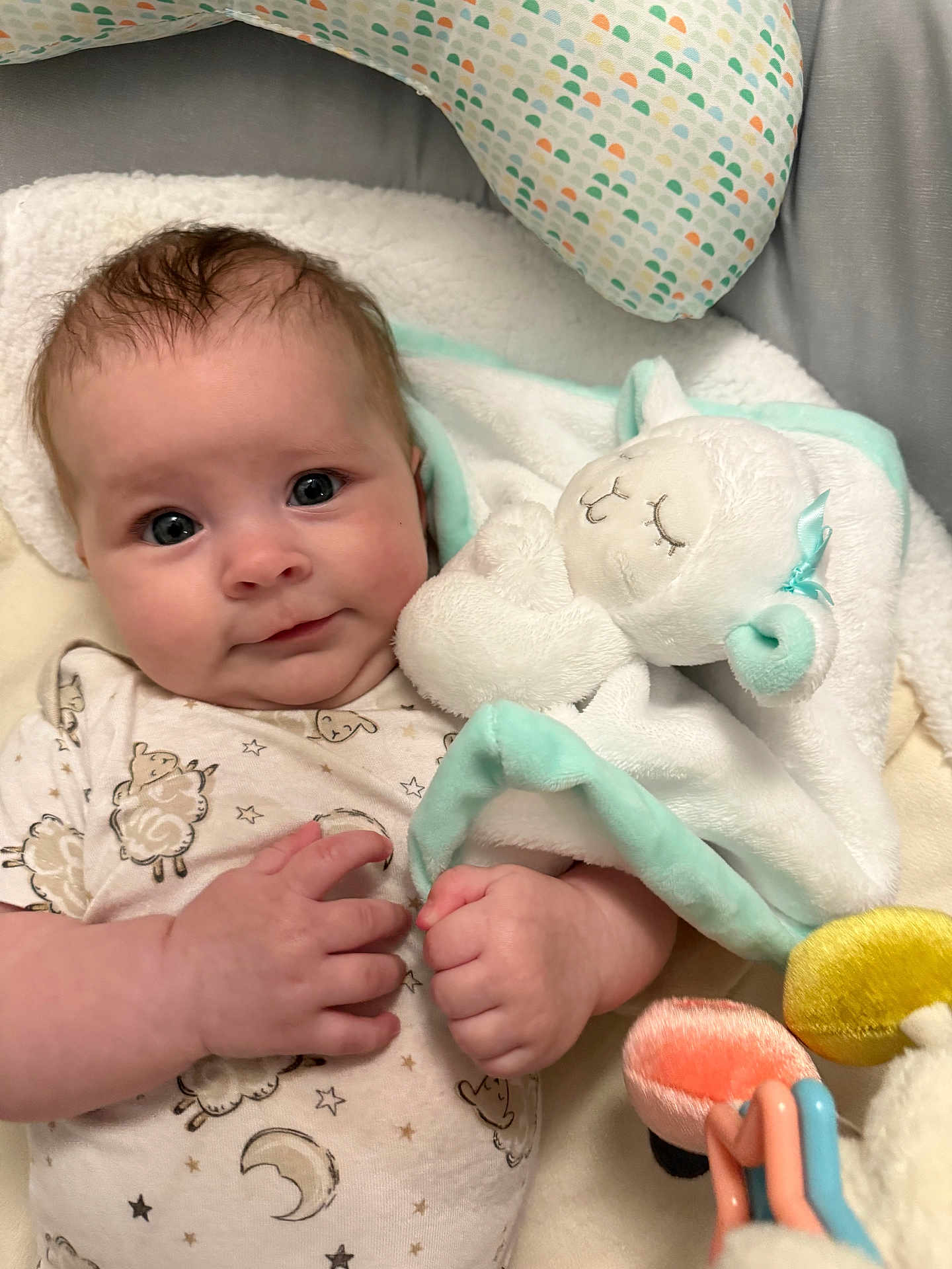 Ahsoka Murray is registered to the contest to win money with this photo: baby, infant, plush_toy, blanket, sleepy_toy, cozy, cute, soft_toy, patterned_clothing, hand, face, blue_eyes, indoor, closeup, smiling, newborn, child, comfort, warm, resting