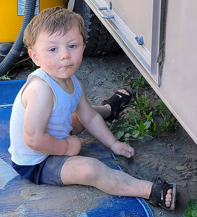Lucius is registered to the contest to win money with this photo: baby_toddler_clothing, chest, electric_blue, finger, foot, fun, grass, human_leg, joint, knee, leg, leisure, person, plant, shorts, sock, sportswear, t_shirt, thigh, thumb