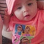 Azalea is registered to the contest to win money with this photo: baby, child, pink_hat, pink_clothing, cartoon_print, person, striped_shirt, infant, cute, portrait, indoor, holding, face, headwear, toddler, casual, relaxed, skin, human, young