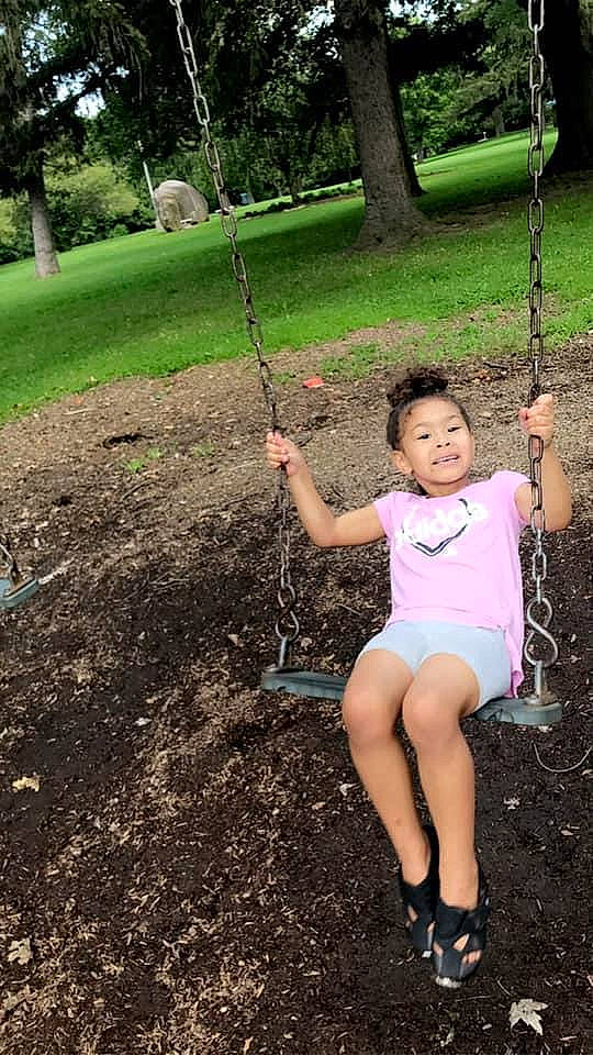 Alilyanna is registered to the contest to win money with this photo: child, fun, grass, green, happy, human_leg, joy, leg, leisure, people_in_nature, person, plant, playground, recreation, shorts, sitting, swing, t_shirt, thigh, toddler