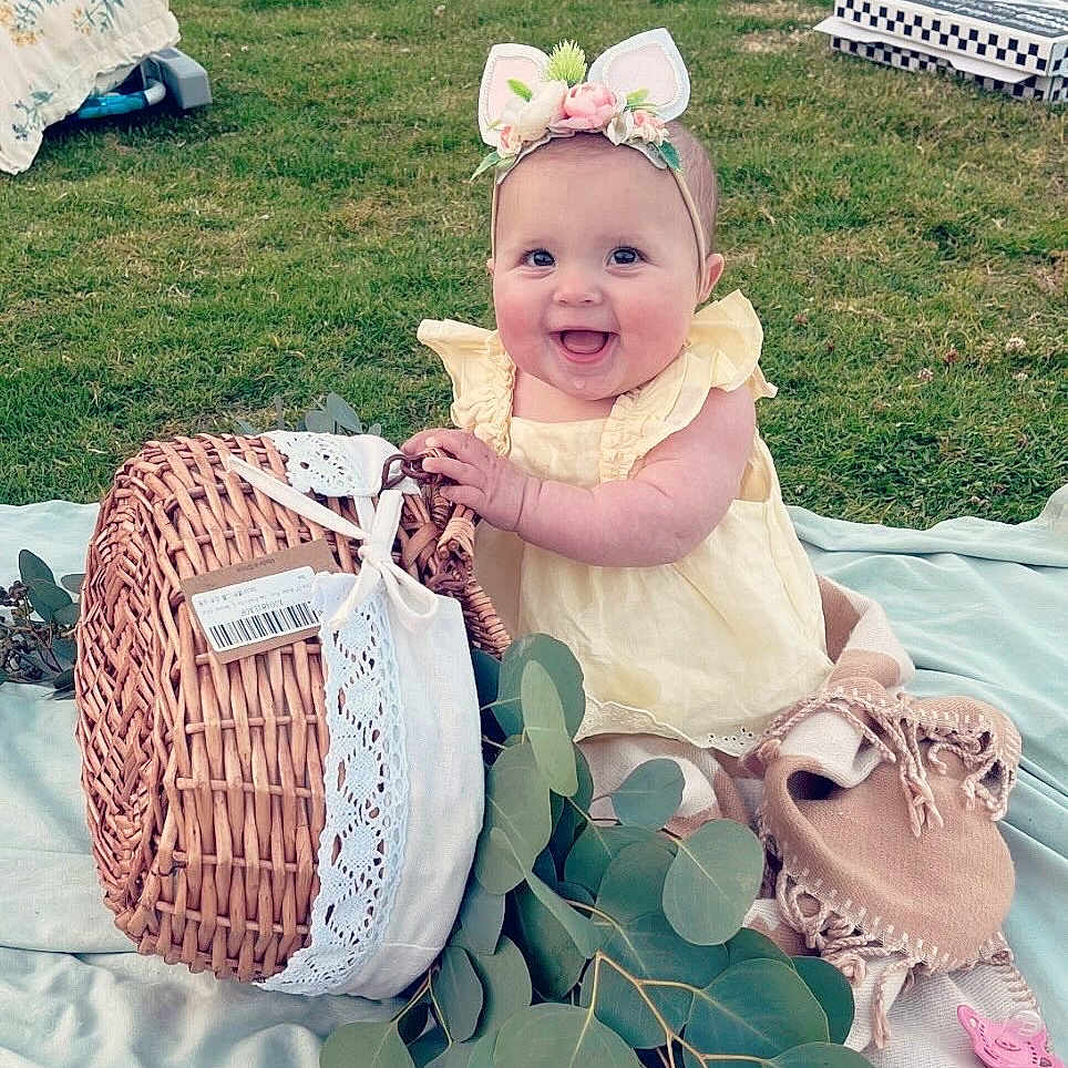 Noelle joined the competition — help win amazing prizes! baby, backyard, basket, clothing, dress, face, fun, grass, hat, head, lawn, leisureactivities, nature, outdoors, person, photography, picnic, plant, portrait, yard