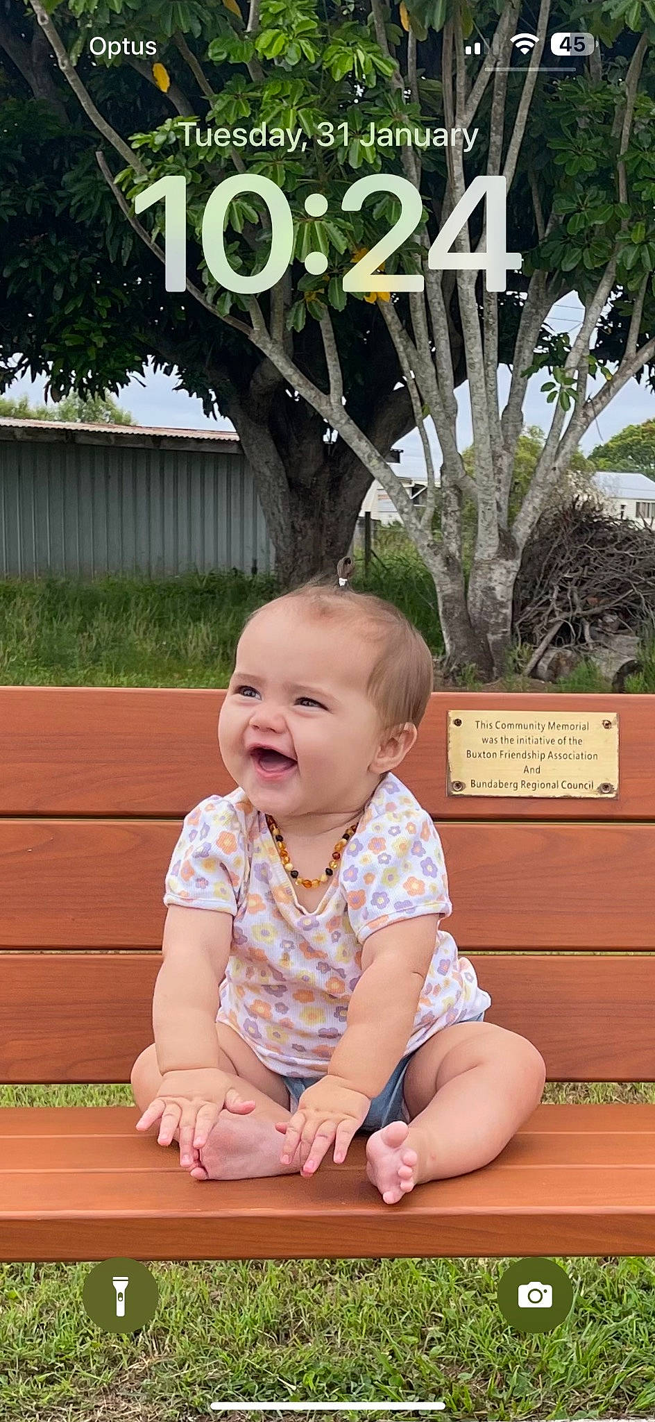 Addilynn is registered to the contest to win money with this photo: baby, baby_toddler_clothing, cheek, child, crawling, eye, flooring, fun, grass, happy, leaf, leisure, mammal, person, plant, skin, sleeve, smile, toddler, tree