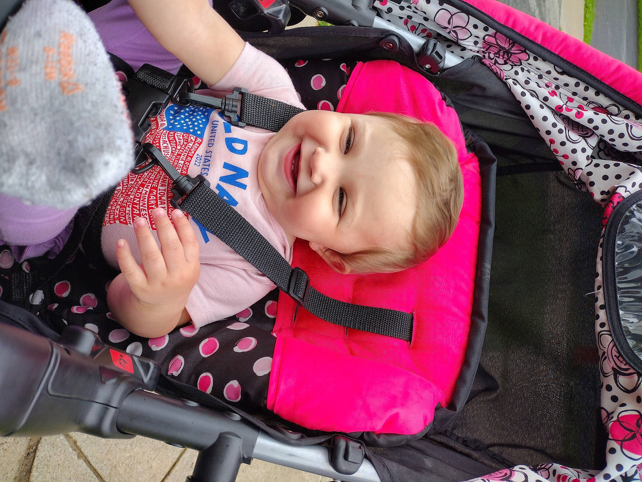Amber joined the competition — help win amazing prizes! baby, baby_carriage, baby_products, baby_toddler_clothing, cheek, child, event, fashion_accessory, fun, grass, happy, joy, magenta, pattern, person, pink, product, red, skin, smile