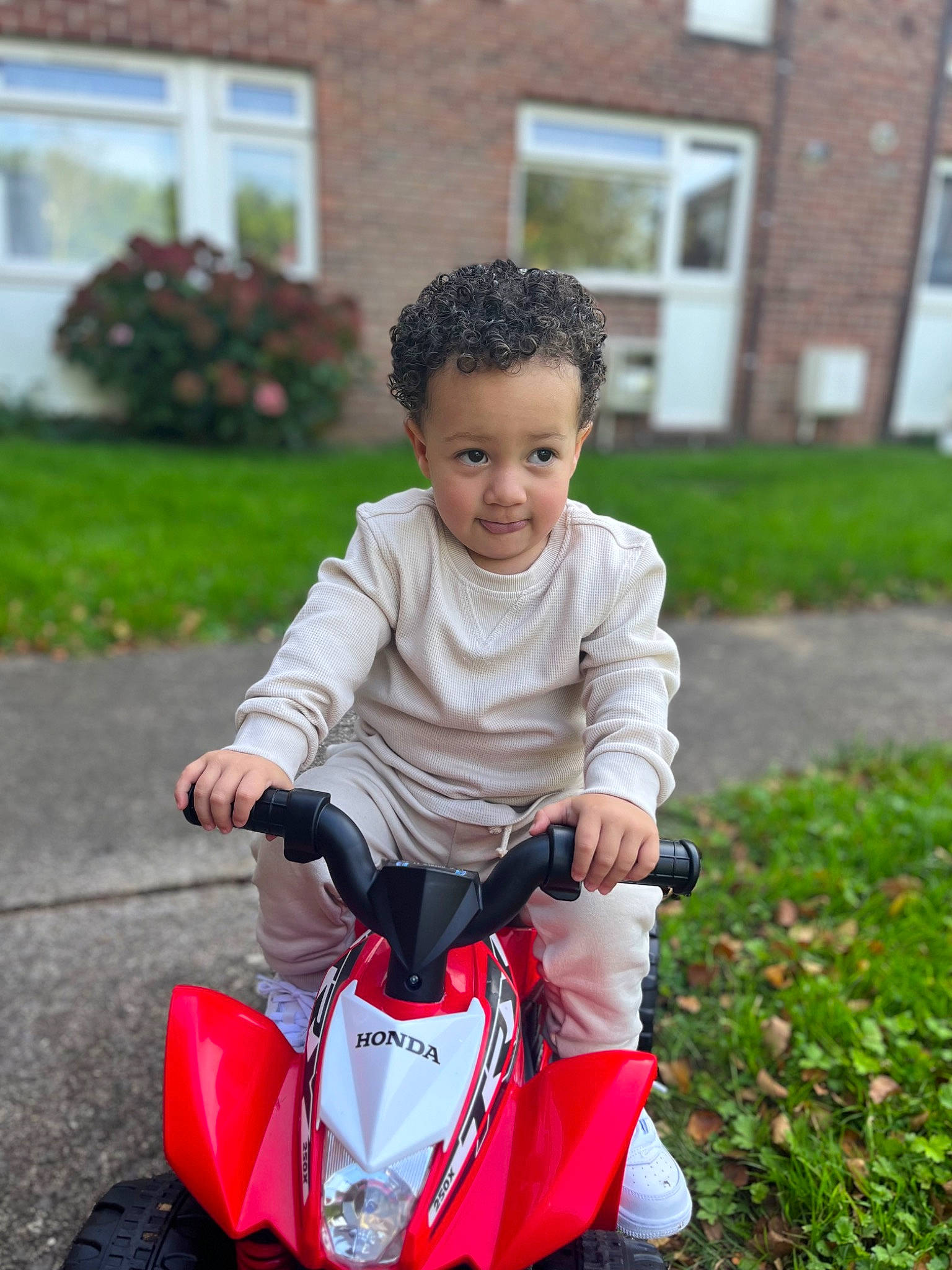 Cairo joined the competition — help win amazing prizes! automotive_design, automotive_lighting, automotive_tire, child, grass, happy, house, lawn, motor_vehicle, person, plant, recreation, riding_toy, rolling, smile, tire, toddler, toy, vehicle, wheel