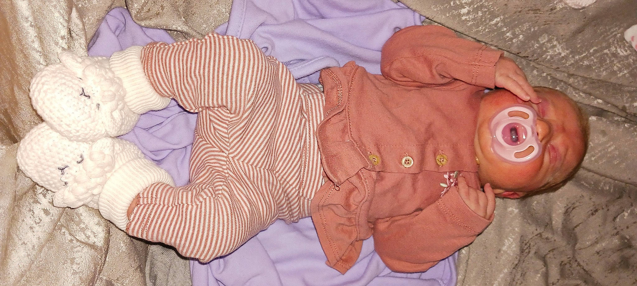 Eva is registered to the contest to win money with this photo: baby_products, baby_toddler_clothing, brown, child, comfort, linens, pattern, peach, person, pink, sleeve, wool, woolen, wrinkle