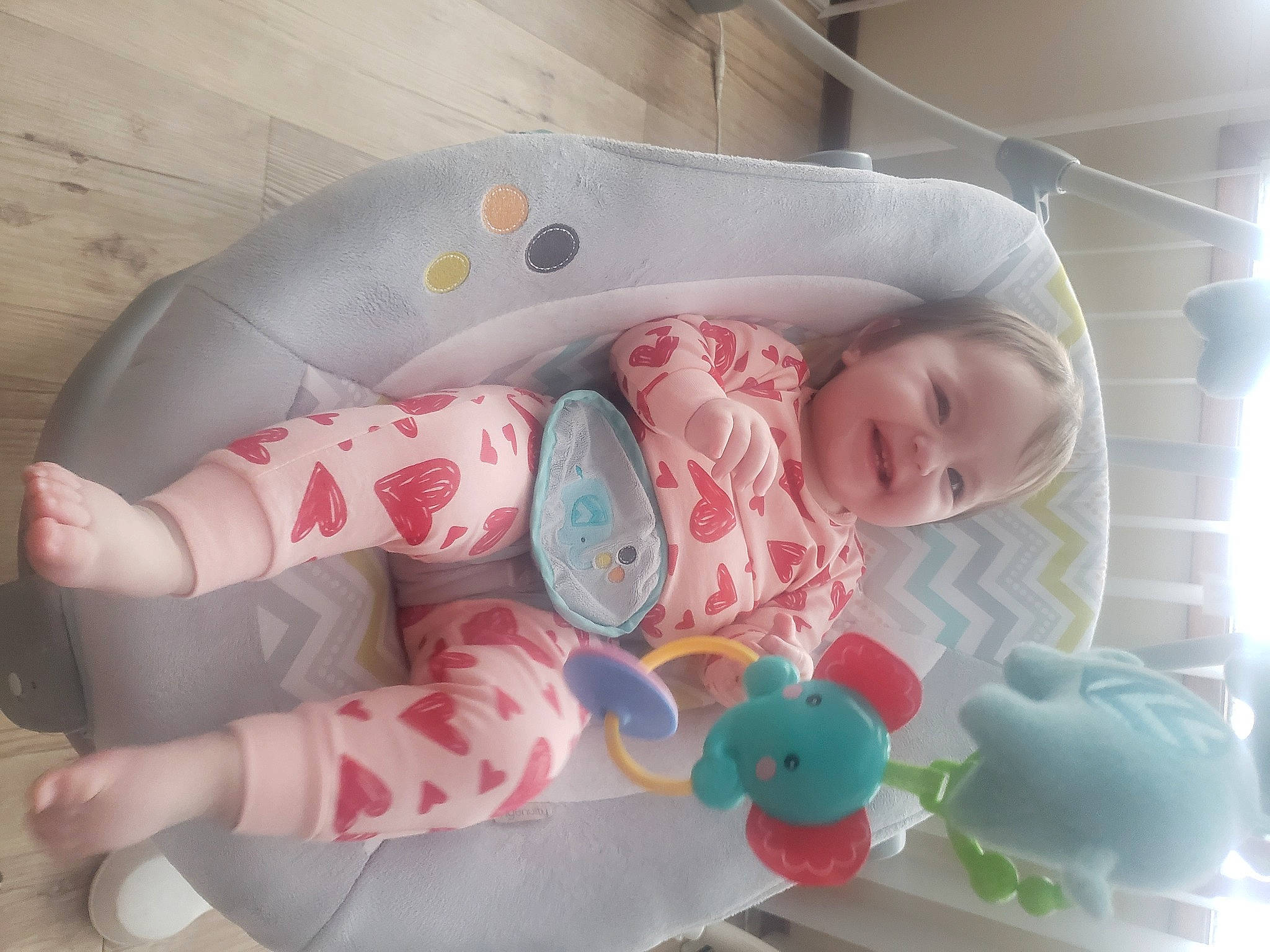 Emily is registered to the contest to win money with this photo: baby, baby_products, baby_toddler_clothing, baby_toys, bedtime, cheek, child, comfort, joy, linens, pattern, person, pink, plastic, product, room, sitting, skin, sleep, sleeve