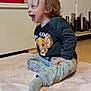 éden participe au concours pour gagner de l'argent avec cette photo : baby, blanket, cabinet, child, clothing, cute, floor, happy, home, indoor, laughing, lion_king, pajamas, person, photograph, pony_tail, sitting, smiling, toddler, young_child