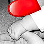 baby, infant, hand, adult_hand, holding_hands, heart_emoji, face_overlay, ear, arm, black_and_white, high_contrast, carpet, sleeve, skin, close_up, palm, tiny_fingers, tenderness, bonding, portrait