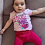 adorable, baby, casual_clothing, child, comfortable, couch, cute, earrings, expression, eyes, face, indoors, infant, leggings, love_message, lying_down, pink_shirt, soft_furniture, sparkle_text, winking_heart