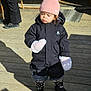 Max participe au concours pour gagner de l'argent avec cette photo : child, toddler, winter_clothing, pink_hat, mittens, jacket, boots, outdoor, wooden_deck, sunlight, shadow, person, cute, cold_weather, fashion, standing, expression, daylight, hat_with_pom_poms, black_jacket