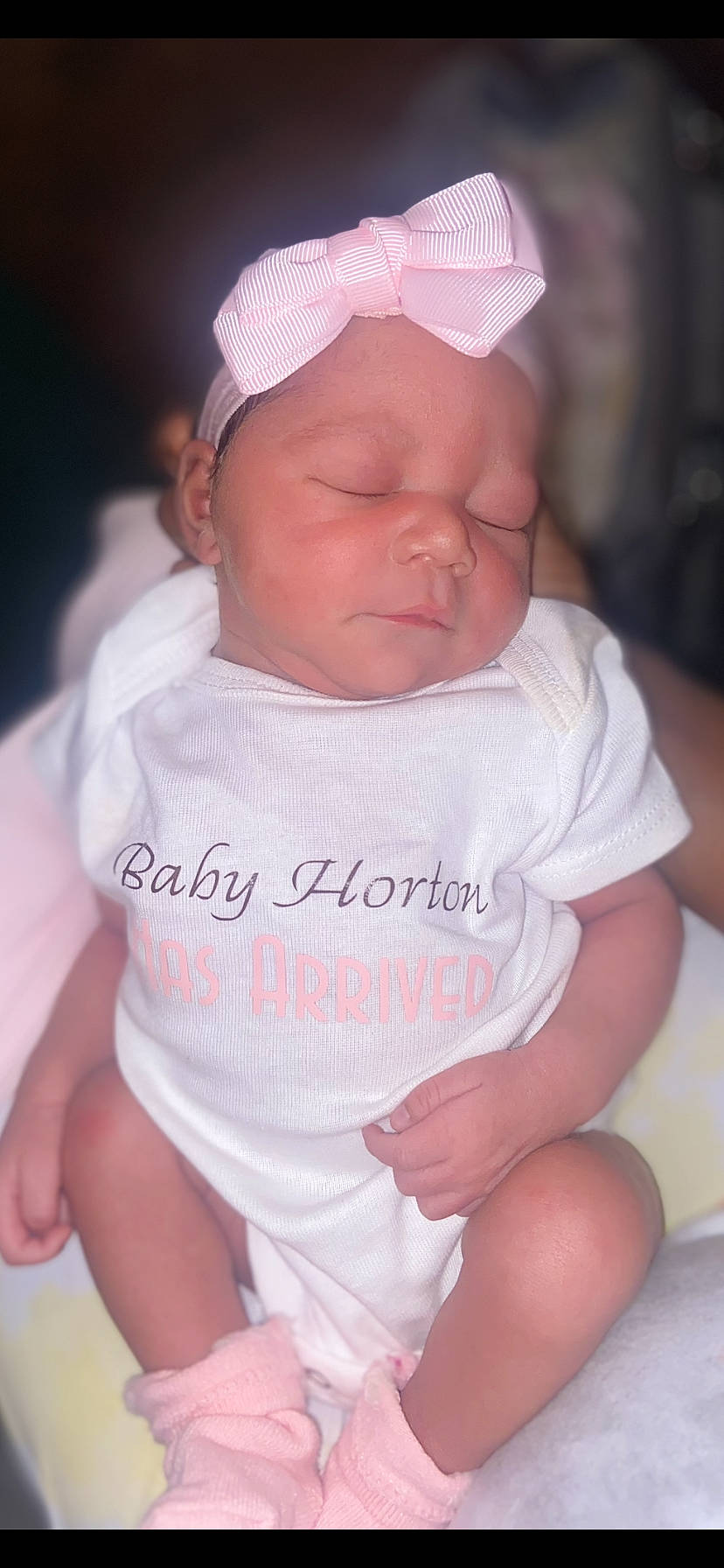 Gracelyn is registered to the contest to win money with this photo: baby, baby_toddler_clothing, cap, cheek, chin, dress, eye, eyebrow, facial_expression, finger, hand, headgear, human_body, lip, mouth, nose, person, pink, skin, sleeve