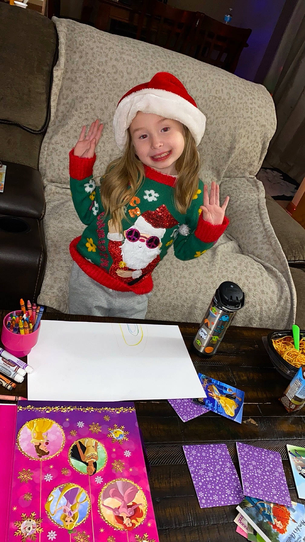 Athena is registered to the contest to win money with this photo: art, baby_toddler_clothing, child, christmas_eve, event, fun, happy, headwear, holiday, joy, lap, magenta, pattern, person, play, purple, recreation, sitting, smile, sock