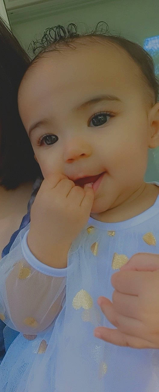 Talia is registered to the contest to win money with this photo: baby, baby_grabbing_for_something, baby_toddler_clothing, cheek, child, chin, clothing, eye, eyebrow, eyelash, finger, forehead, hand, iris, lip, organ, person, portrait_photography, skin, thumb