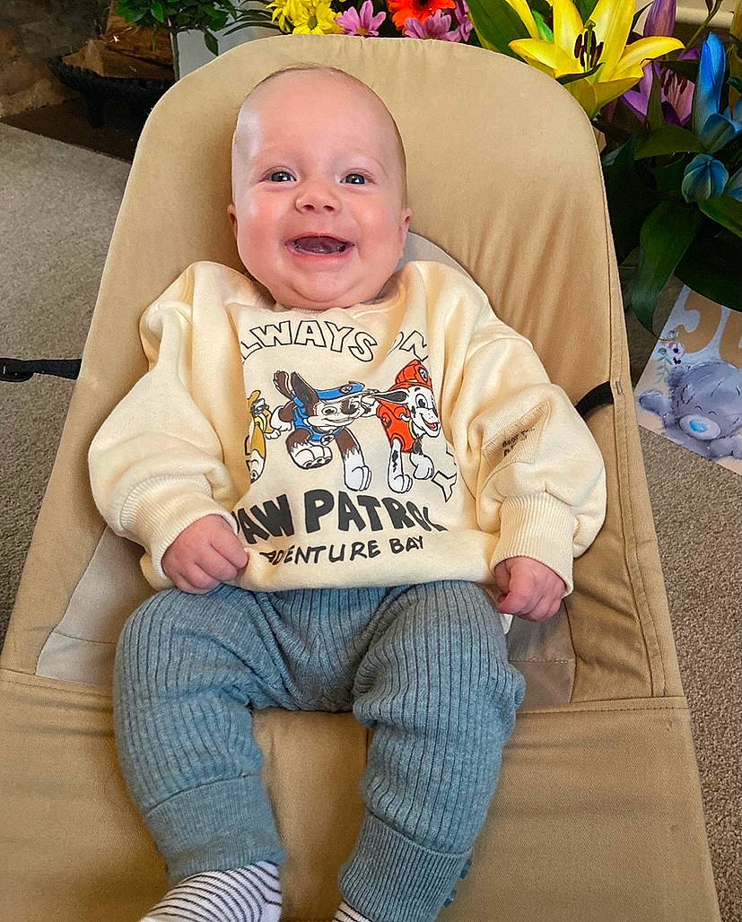 Drew is registered to the contest to win money with this photo: baby, baby_toddler_clothing, chair, child, clothing, comfort, cool, eye, flower, green, happy, head, orange, person, plant, sitting, sleeve, smile, t_shirt, toddler