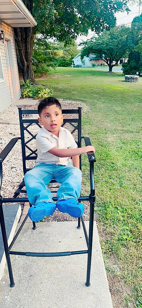 Dominick Jeonarine is registered to the contest to win money with this photo: baby_toddler_clothing, chair, child, comfort, electric_blue, fun, grass, green, happy, leisure, outdoor_furniture, people_in_nature, person, photograph, plant, recreation, shorts, sitting, surprise, t_shirt