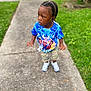 Jazier is registered to the contest to win money with this photo: toddler, child, boy, cornrows, blue_tshirt, sonic_the_hedgehog, graphic_tee, camo_shorts, sneakers, sidewalk, grass, outdoor, portrait, standing, casual_clothing, curious_expression, daylight, young_child, person, nature