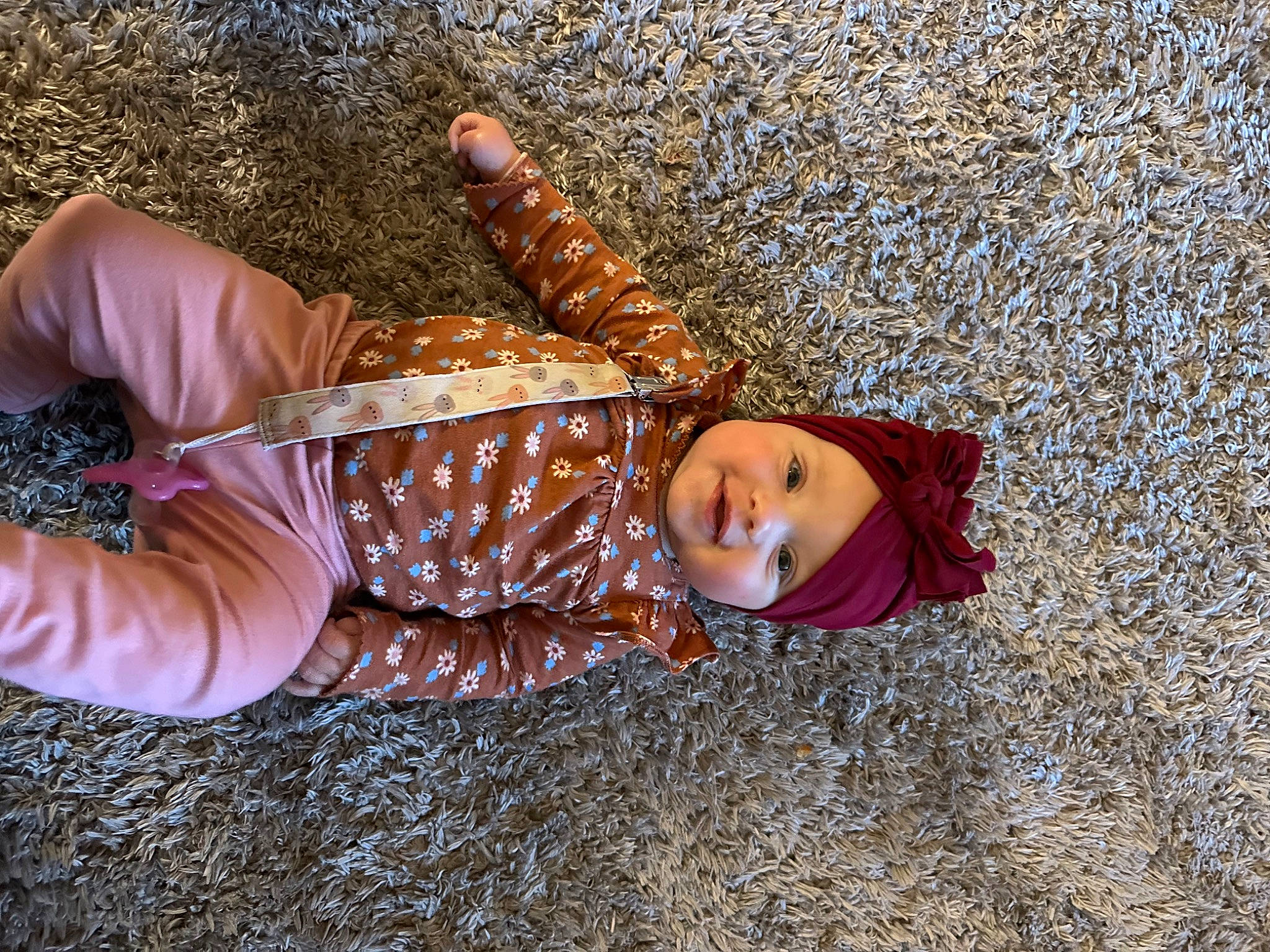 Tatum is registered to the contest to win money with this photo: child, doll, fashion_accessory, fawn, flooring, fun, fur, grass, happy, hat, headwear, pattern, people_in_nature, person, plant, sitting, smile, soil, toddler, toy