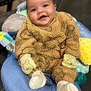 Romeo joined the competition — help win amazing prizes! baby, smiling, infant, cozy_clothing, teddy_bear_outfit, mittens, socks, cushion, colorful, indoor, portrait, cute, happy, child, comfort, seat, soft_texture, closeup, person, warm
