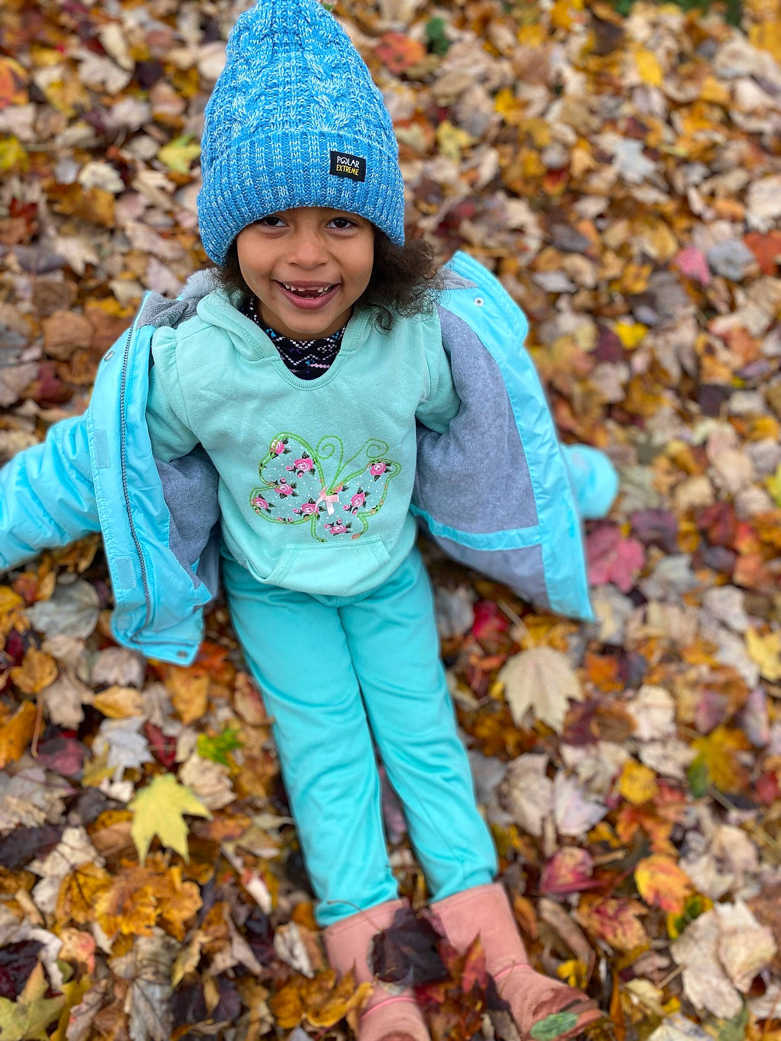 Penny is registered to the contest to win money with this photo: cap, child, deciduous, electric_blue, fun, grass, happy, headwear, joy, knit_cap, leaf, outerwear, people, people_in_nature, person, photograph, plant, smile, toddler, tree