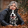animal, autumn, bandana, black_and_white_dog, close_up, companion, dog, fallen_leaves, fashion, happy, leather_jacket, leopard_print, nature, outdoor, pet, photography, portrait, smiling, woman, woodland