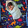 Josiah joined the competition — help win amazing prizes! baby, blanket, child, colorful, cozy, cute, dinosaur, fleece, head, indoors, infant, letters, newborn, pattern, peaceful, resting, sleeping, soft, swaddled, wrapped