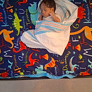 Josiah joined the competition — help win amazing prizes! baby, blanket, child, colorful, cozy, cute, dinosaur, fleece, indoors, infant, newborn, nursery, pattern, peaceful, portrait, resting, sleeping, small, soft, wrapped