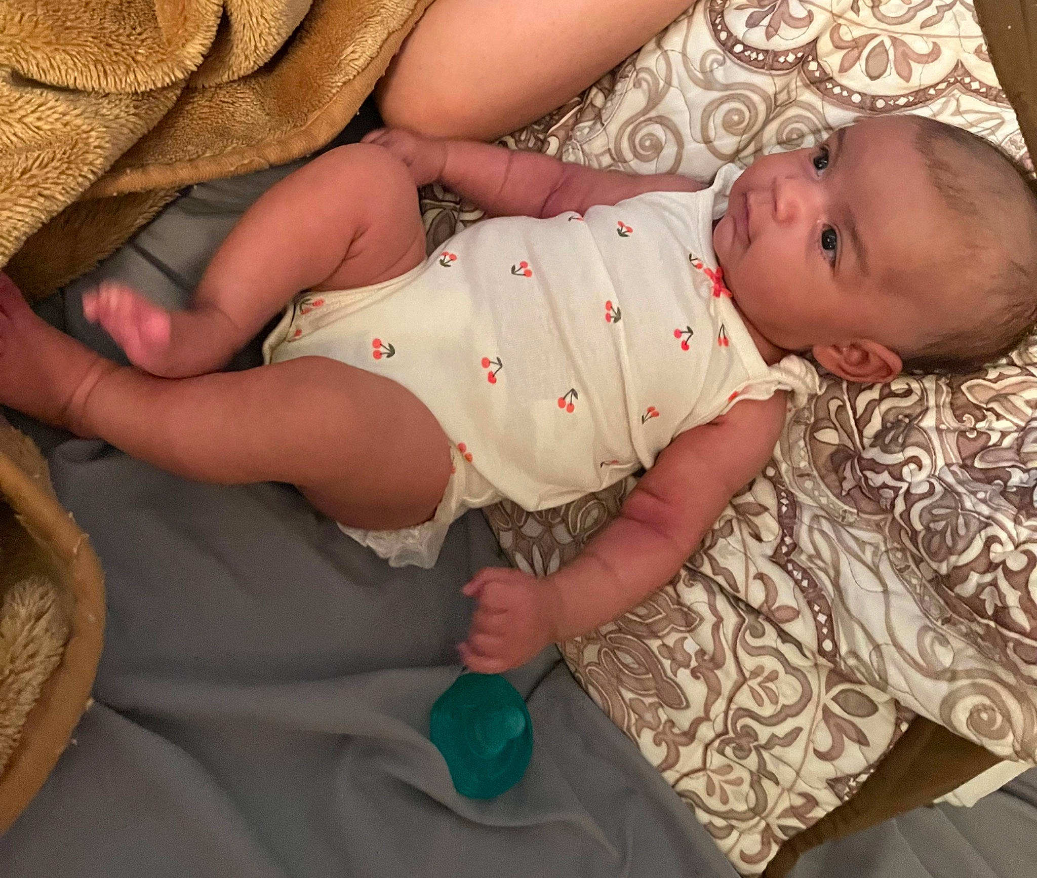 Alaïa joined the competition — help win amazing prizes! arm, baby, baby_toddler_clothing, child, comfort, face, finger, grass, hand, human_body, human_leg, linens, nail, pattern, person, sitting, skin, sleeve, textile, thigh