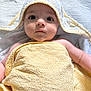 Harrison is registered to the contest to win money with this photo: baby, towel, yellow_towel, hooded_towel, infant, face, eyes, skin, blanket, white_background, soft_texture, cute, child, lying_down, portrait, indoors, expression, young_child, wrapped, comfort