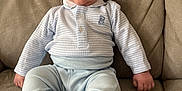 Harrison is registered to the contest to win money with this photo: baby, child, infant, sitting, couch, sofa, clothing, socks, face, blue, pastel, cute, expression, indoors, cozy, person, portrait, small, furniture, home