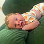 Teddy joined the competition — help win amazing prizes! baby, infant, smile, happy, couch, green, onesie, patterned_clothing, lying_down, cute, child, face, skin, head, arm, indoor, plush, soft, comfort, relax