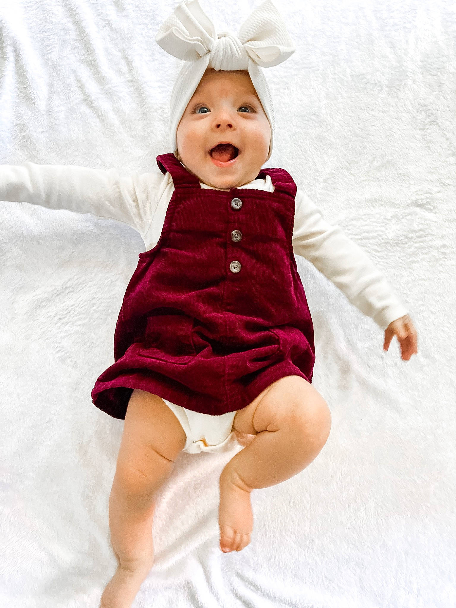 Raegan joined the competition — help win amazing prizes! baby_toddler_clothing, day_dress, dress, face, gesture, happy, head, headgear, headwear, human_body, magenta, one_piece_garment, person, pink, product, purple, skin, sleeve, smile, textile